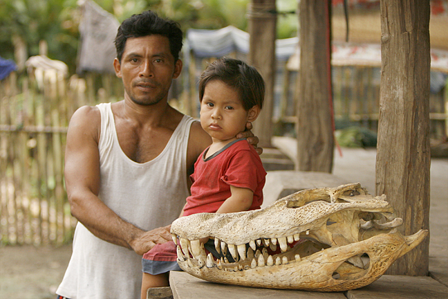 Father and Son with caiman skull, Amazon village, Peru