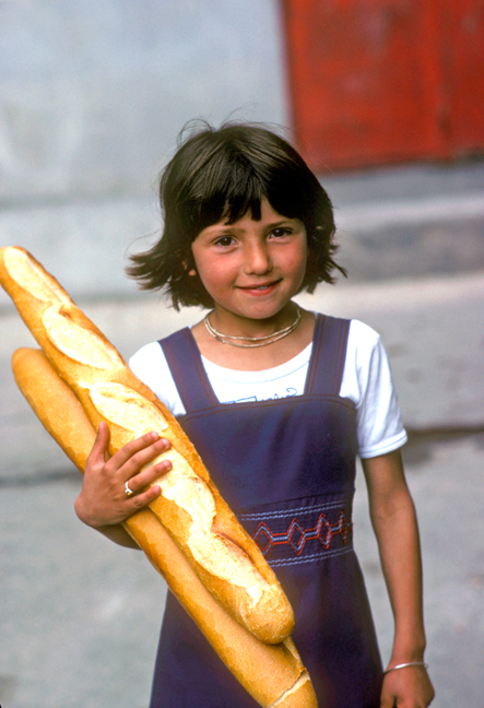 French Girl carrying bread, France